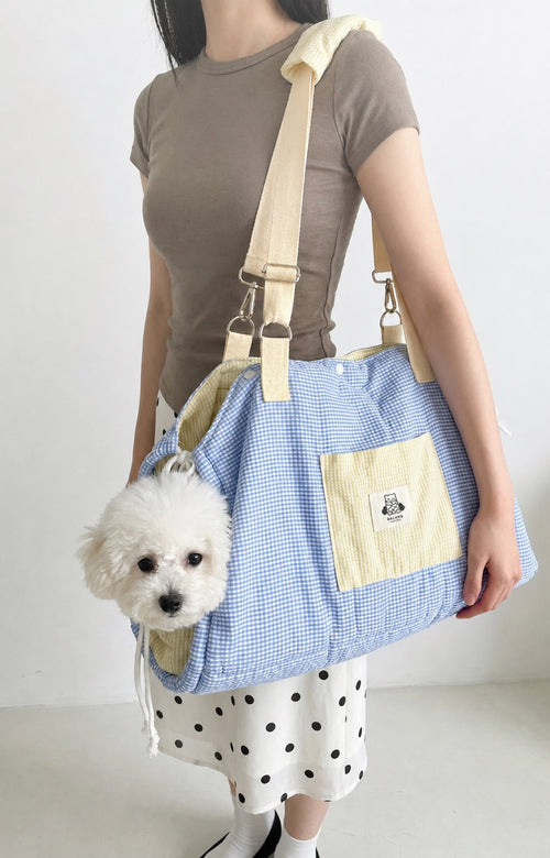 Small white dog carried in PrismTail Breeze Tote pet carrier bag