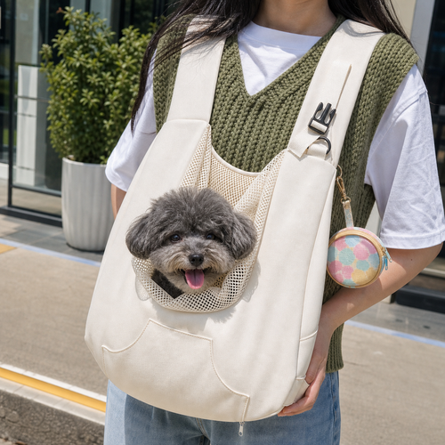 Oat canvas pet sling carrier worn front-carry on a city street